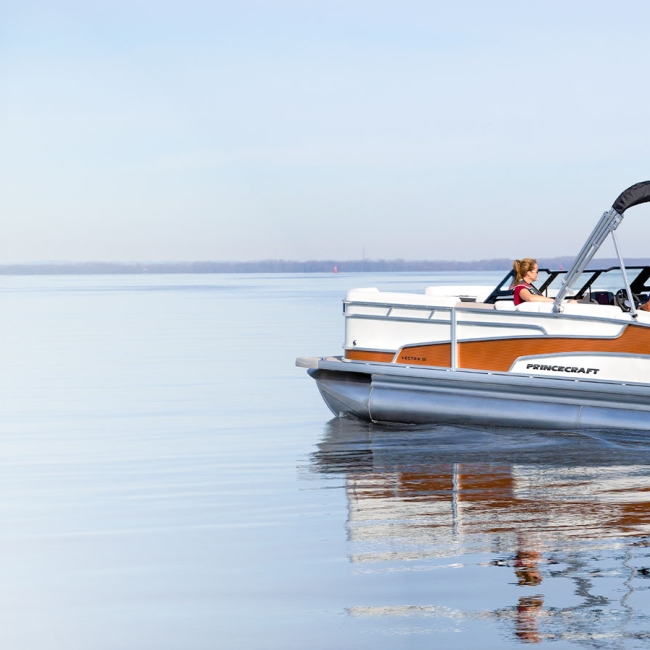 princecraft pontoon on a still lake