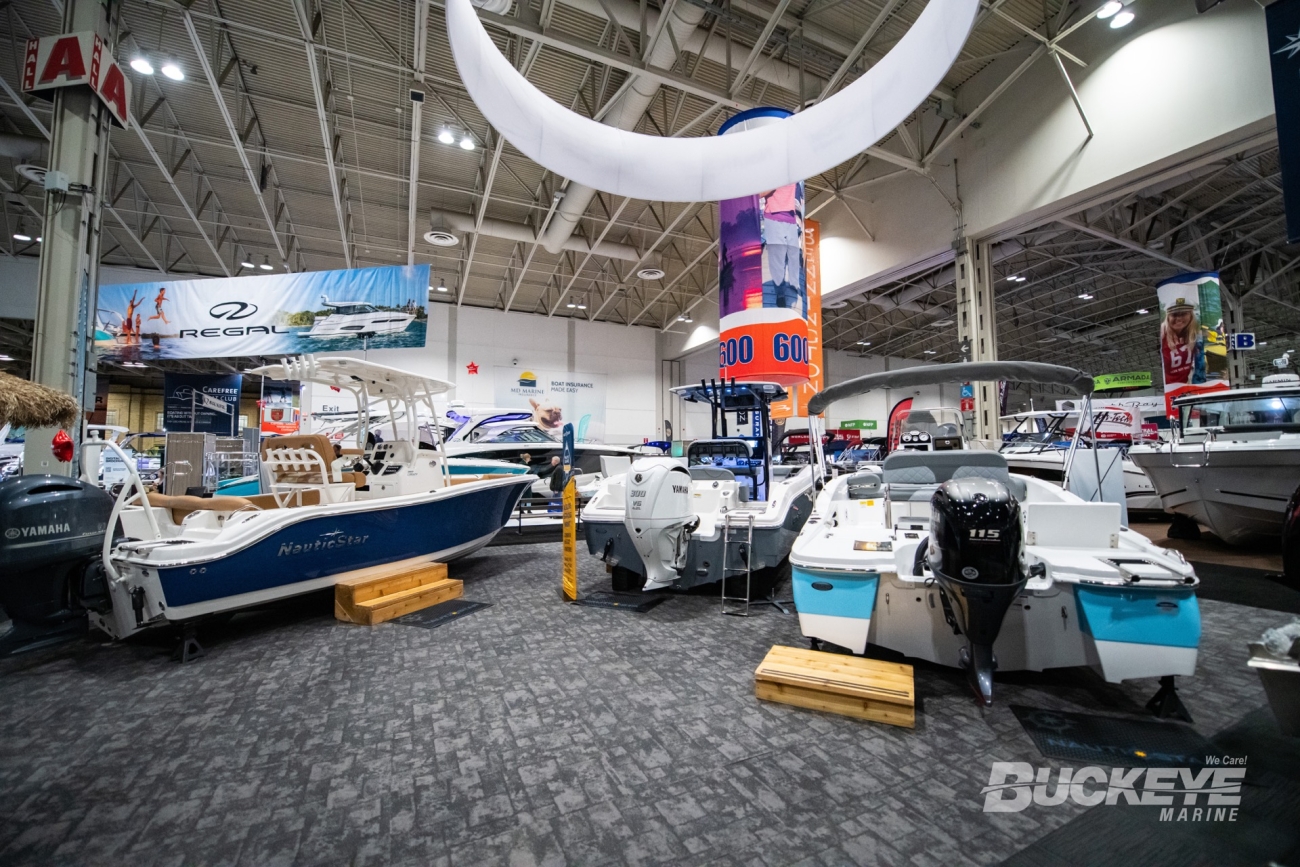 behind three center console boats from nauticstar at the toronto international boat show