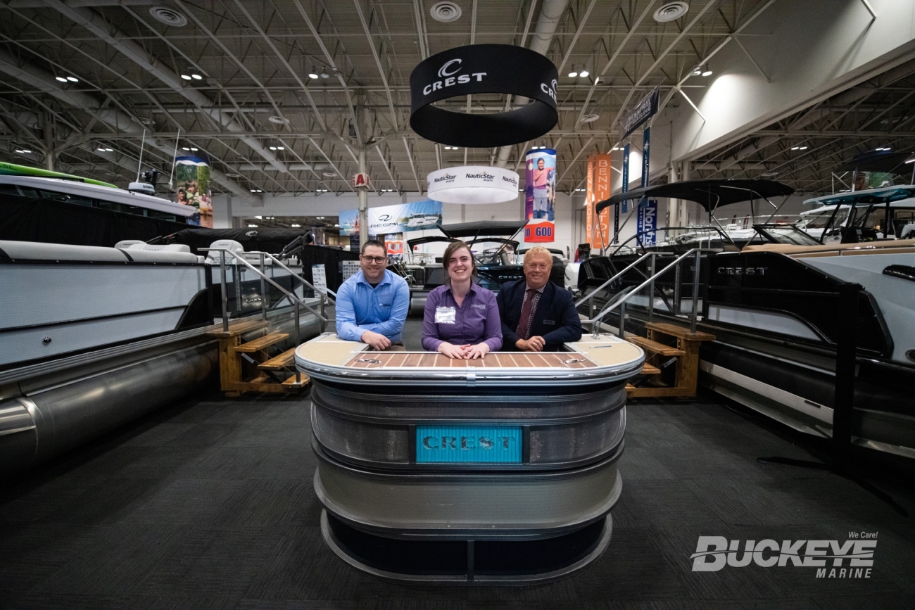 buckeye marine sales team posing at a podium ready to sell boats