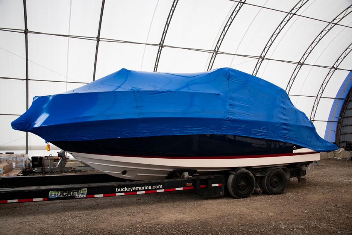 Large shrink wrapped boat in a quonset hut