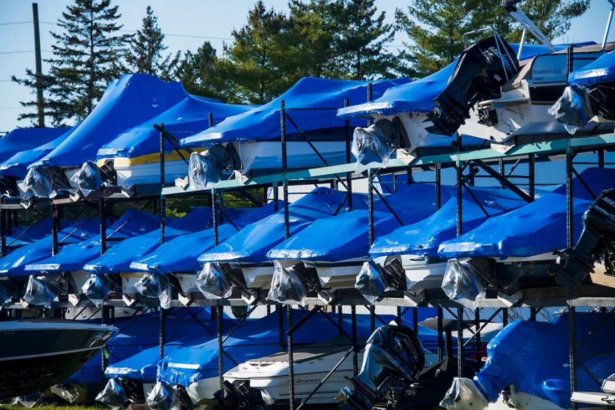 Shrink wrapped boats on a storage structure